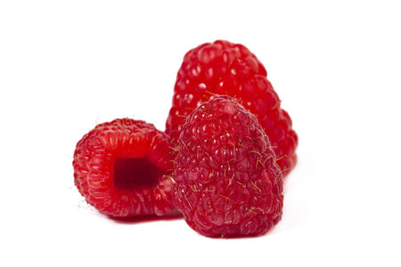 Image of three raspberries against white background