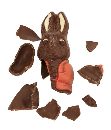 Cracked Easter chocolate bunny scattered on a white surfaceの写真素材