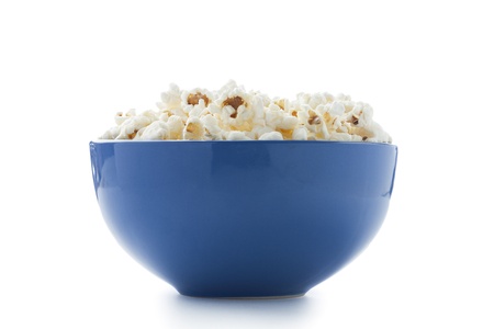 Blue bowl filled with popcorn isolated in a white backgroundの写真素材