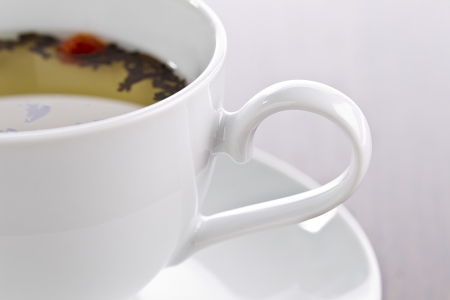 Close-up cropped shot of tea cup and saucer with lime tea.の写真素材