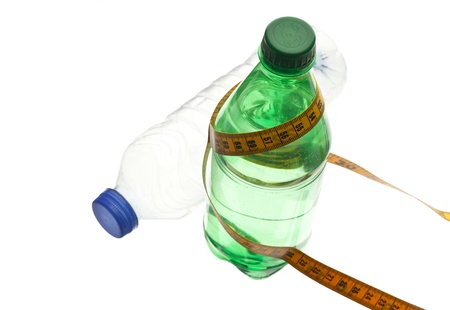 Two bottled waters with a tape measure on a white backgroundの写真素材