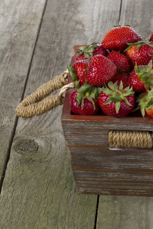 Close-up cropped shot of stack of strawberries in wooden box.の写真素材