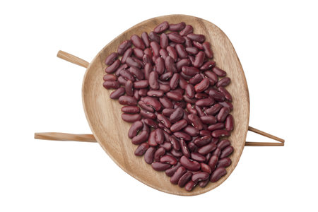 Red beans in a wooden plate with chopstick over a top view image