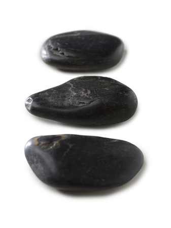 Close up image of three spa stones against white backgroundの写真素材