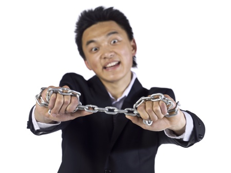 Image of asian teenage guy holding metal chain against white backgroundの写真素材
