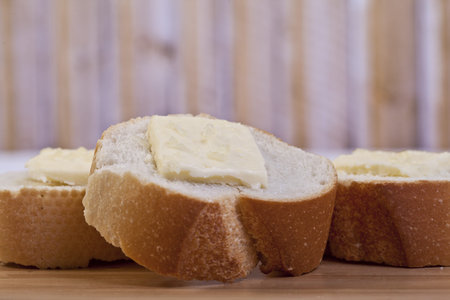 Closed up shot of baguette slices top with creamy butter