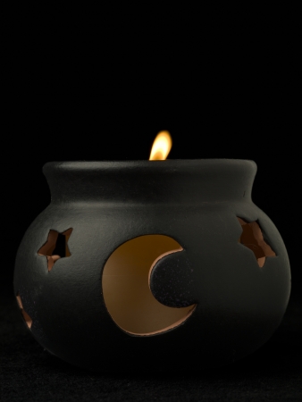 Image of witch pot candle holder against black backgroundの写真素材