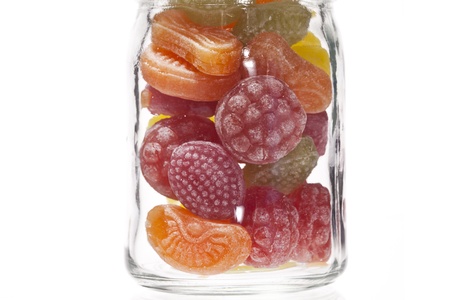 Close-up image of a transparent jar with fruit flavored candiesの写真素材