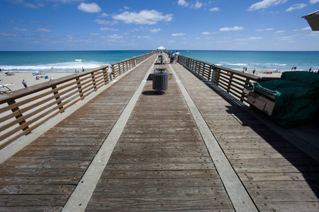 A dock goes off into the distance in Palm Beach, Florida.の写真素材