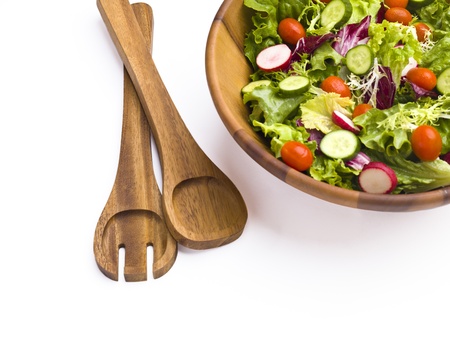 Tongs and a garden salad on a white background.の写真素材