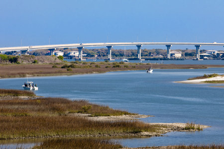The Vilano Beach Bridge is located just north of the historic fort Castillo de San Marcos Fort.  The shot is taken from the vantage point of the upper portion of the fort with views of the ICW and several fishing boats.のeditorial素材