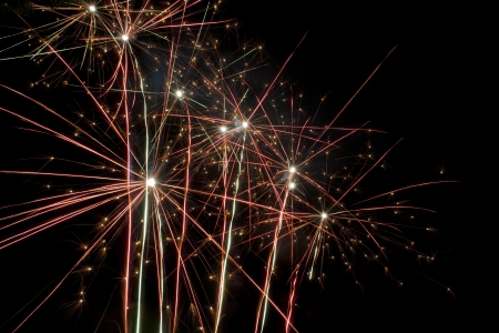Fireworks exploding into vibrant colors that resemble giant flowers in the sky の写真素材
