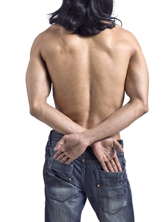 Behind shot of a topless man touching his back pocketsの写真素材
