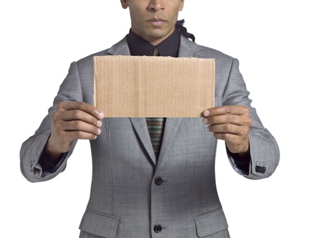 Cropped image of a businessman holding cardboard against the white backgroundの写真素材