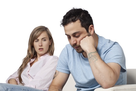 Couple having a relationship difficulties while sitting on the sofaの写真素材