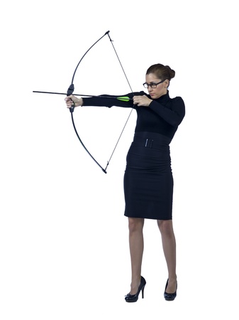 Full length image of a determined businesswoman aiming her bow to the targetの写真素材