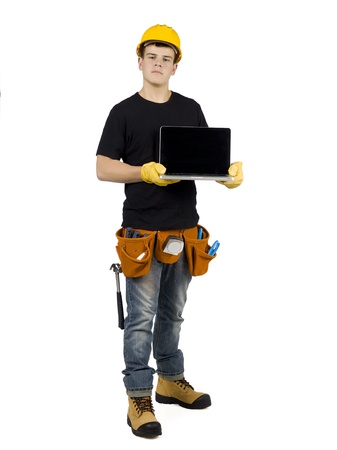 Full length image of a handyman holding a laptopの写真素材