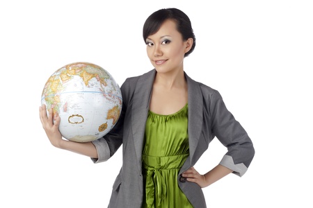 Portrait of attractive asian girl holding globe against white backgroundの写真素材