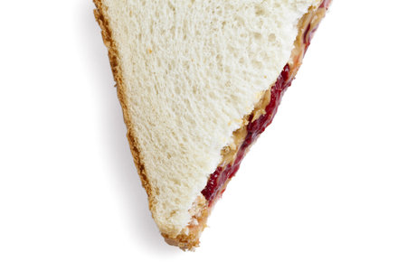 Cropped image of strawberry jam sandwich against white background