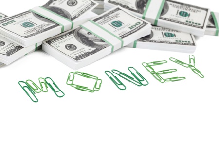 Close up image of money word  made of paperclips and us dollars against white backgroundの写真素材