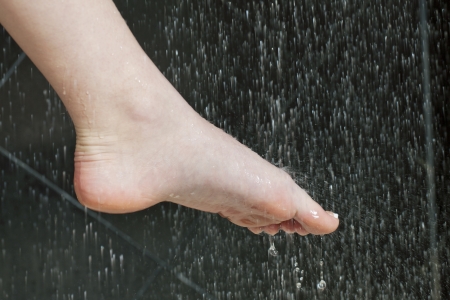 Close-up image of a female foot washing on showerの写真素材