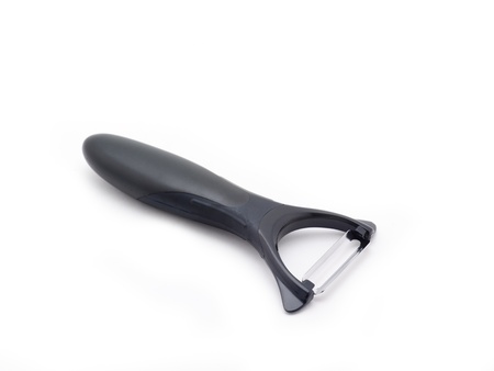 Top view of angled potato peeler on white background.の写真素材