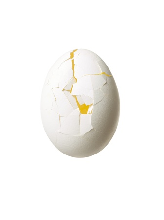 Close-up of cracked egg isolated over white backgroundの写真素材