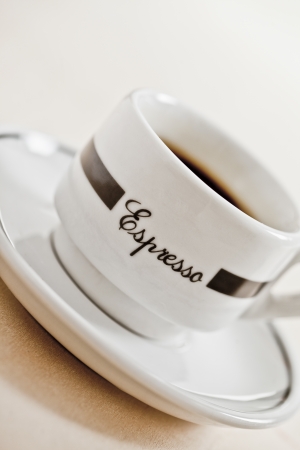 Closed up cup of coffee in a saucerの写真素材