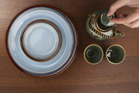 Image of a plate and saucer with teapotの写真素材
