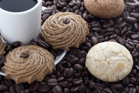 Sugar cookies and black coffee in a coffee beanの写真素材