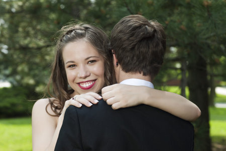 Close-up image of young couple hugging each other outside the parkの写真素材