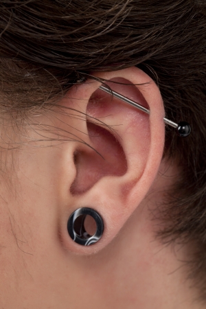 Close-up image of male ear with Flesh Tunnelの写真素材