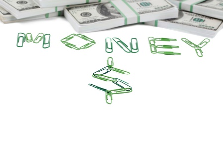 Word money made of paper clips, and a bunch of dollars arranged over a white backgroundの写真素材
