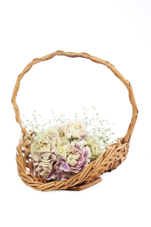 Bouquet of flowers in the wicker basket against the white backgroundの写真素材