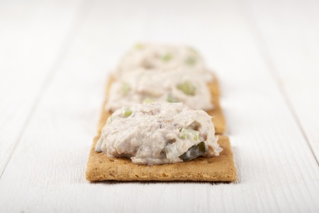Selective focus on cookies with a salmon spread on a wooden tableの写真素材