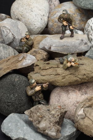 Fighting soldiers hiding on rocksの写真素材