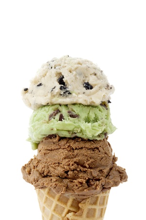 Cropped image of three flavorful scoops of ice cream on the cone against the white surfaceの写真素材