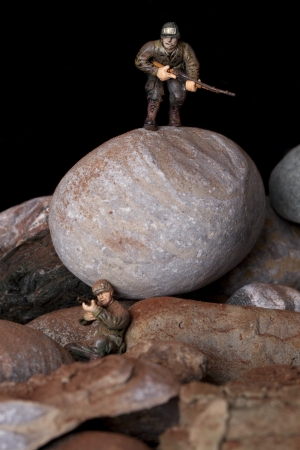 Close up image of two toy military army on battle fieldの写真素材