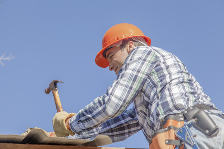 Man working on roof of houseの写真素材