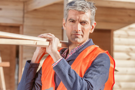 Older serious looking man at construction siteの写真素材