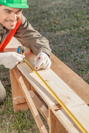 close-up of construction worker hands measuringの写真素材