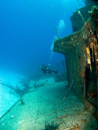 Underwater Photographer Shooting a Sunken Ship in Cayman Bracの写真素材
