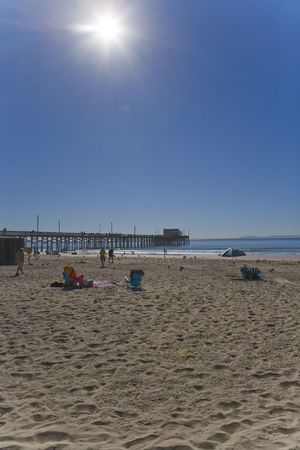 Newport Beach Pier with the Sun high in the Skyの写真素材