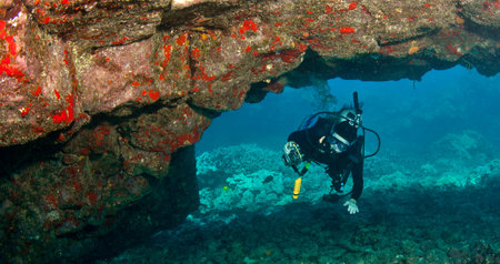 Diver exploring a Lava Arch inKona  Hawaii