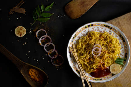 Image of noodels in white plate with props and dark backdropの写真素材