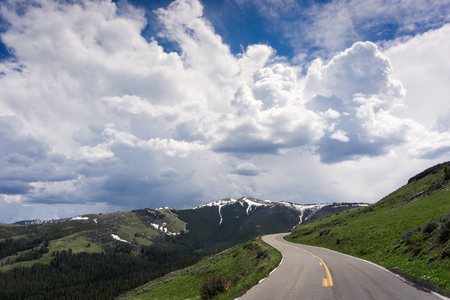 Beautiful drive on a winding road inside Yellowstone National Park, Wyomingの写真素材