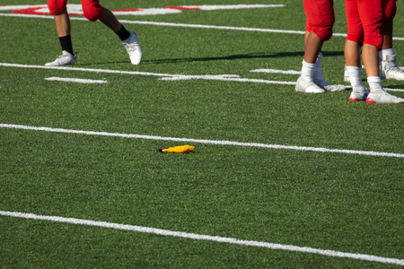 American Football â Penalty Flag thrown on field by the referee during the gameの写真素材