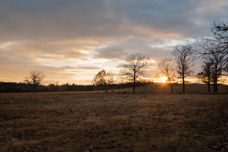 Beautiful golden  Sunset on a Ranch in Oklahoma sky filled with cloudsの写真素材