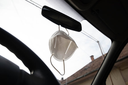 A view of a medical mask on mirror carの写真素材