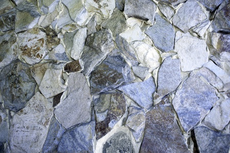 Stones rough hewn and arranged in random order on a wall.の写真素材